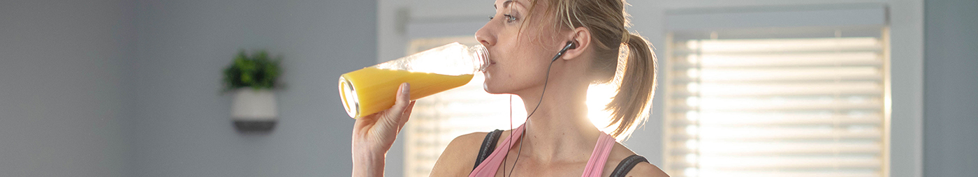 woman drinking orange juice