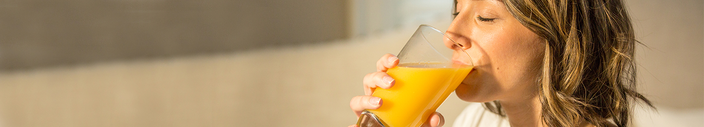 woman drinking orange juice