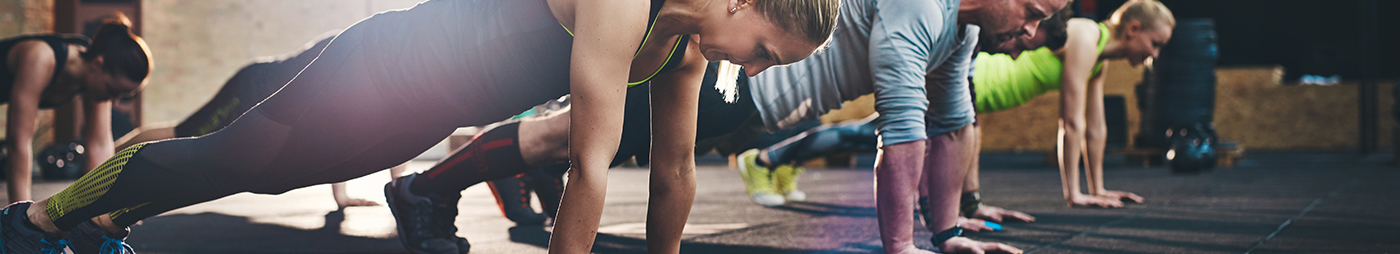 group of men and women doing pushups